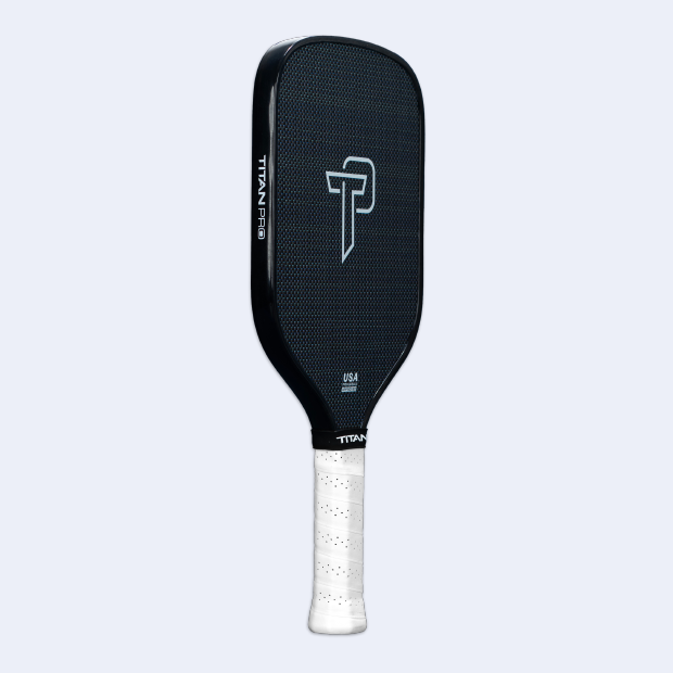 A black Titan Pro Titanium 16L paddle by Titan Pickleball features a textured face, white “P” logo at center, “TITAN PRO” on the side, and a white grip—all set against a light gray background. Perfect for pickleball paddle shoppers.