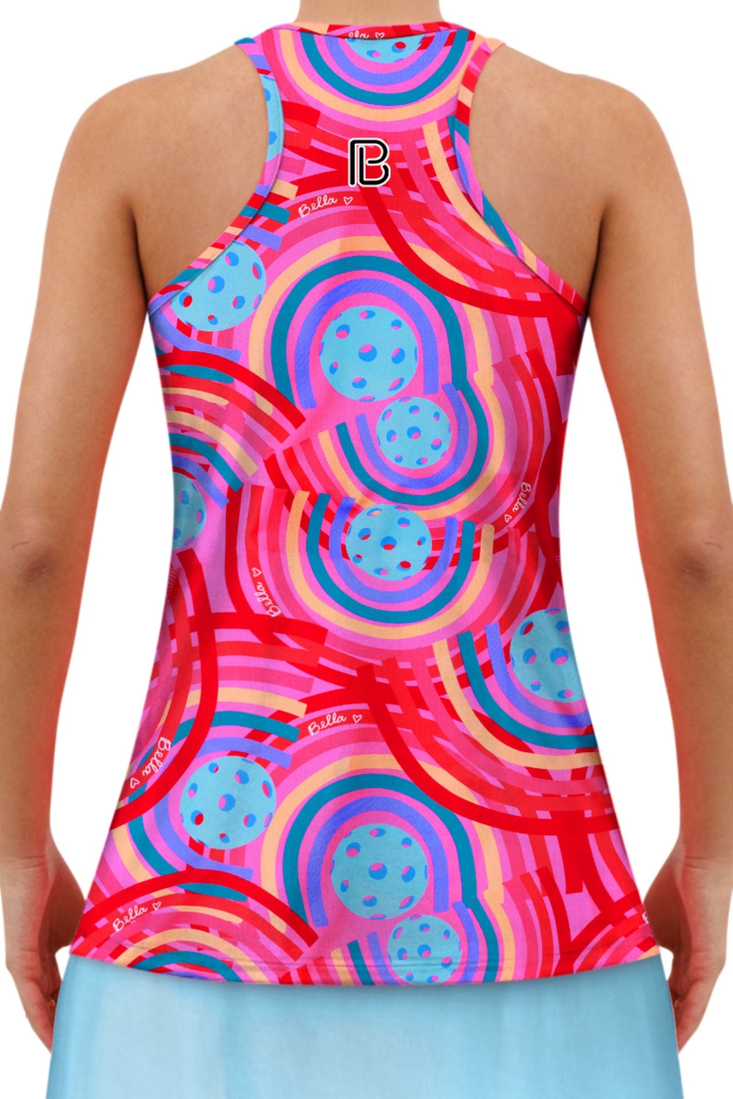A person is wearing the Pickleball Bella PB Racerback Tank Circle, a sleeveless fitted tank with bold red, blue, pink, and purple geometric concentric circles and stripes, plus a small PB logo on the upper back, paired with a light blue skirt.
