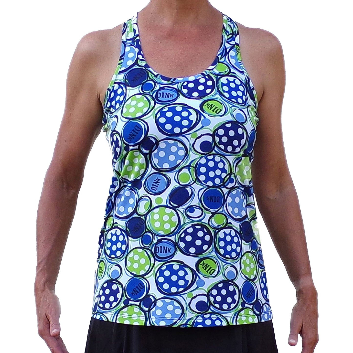 A person models the Pickleball Bella PB Racerback Tank Dink 1, featuring blue, green, and white pickleballs with “DINK” text, paired with a black skirt. Made of performance fabric, the tank is shown on a plain white background without the head visible.