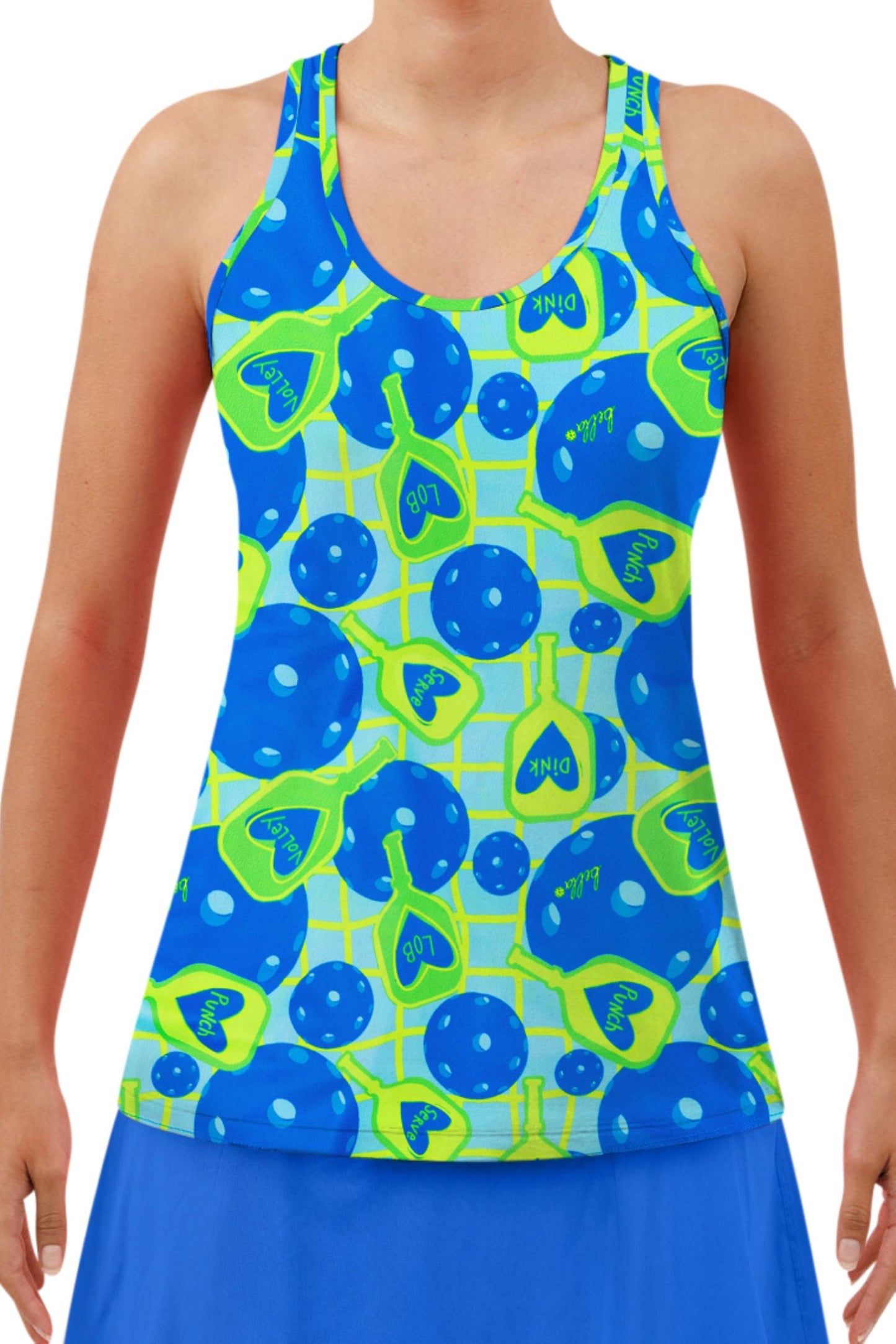 A woman wears the Pickleball Bella PB Racerback Tank Net Worth, featuring a blue and neon green pickleball-themed pattern with paddles, balls, nets, and words like "DINK" and "LOB," paired with a matching blue skirt. Her face is not visible.