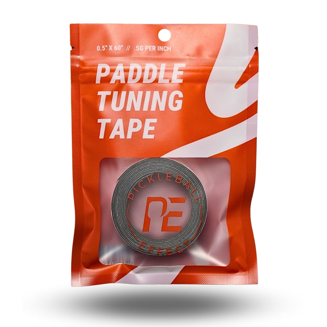 Pickleball Effect Shop Paddle Tuning Tape for pickleball paddle weight and balance adjustment. Features orange packaging with bold white text, 0.5 x 60 size, 5g per inch, and a gray logo tape visible through a clear window.