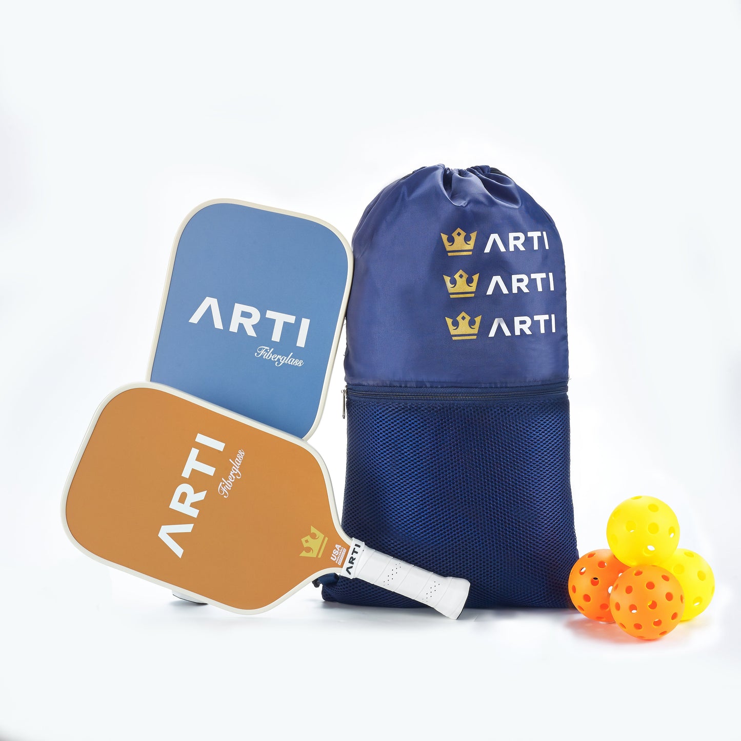 The ARTI Fiberglass "Horizon Duo" Pickleball Paddle Set includes two USAPA-approved paddles (blue and orange), a navy drawstring bag with gold crowns and text, and three yellow balls, all from ARTI, displayed on a white background.