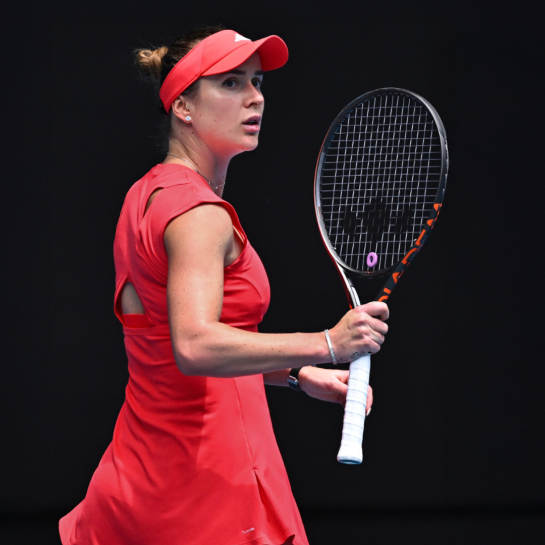 A focused female tennis player in a red dress and cap holds a Diadem Sports Diadem Stencil and Ink Bundle racket in her right hand, looking to the side on a dark background with her hair tied up.