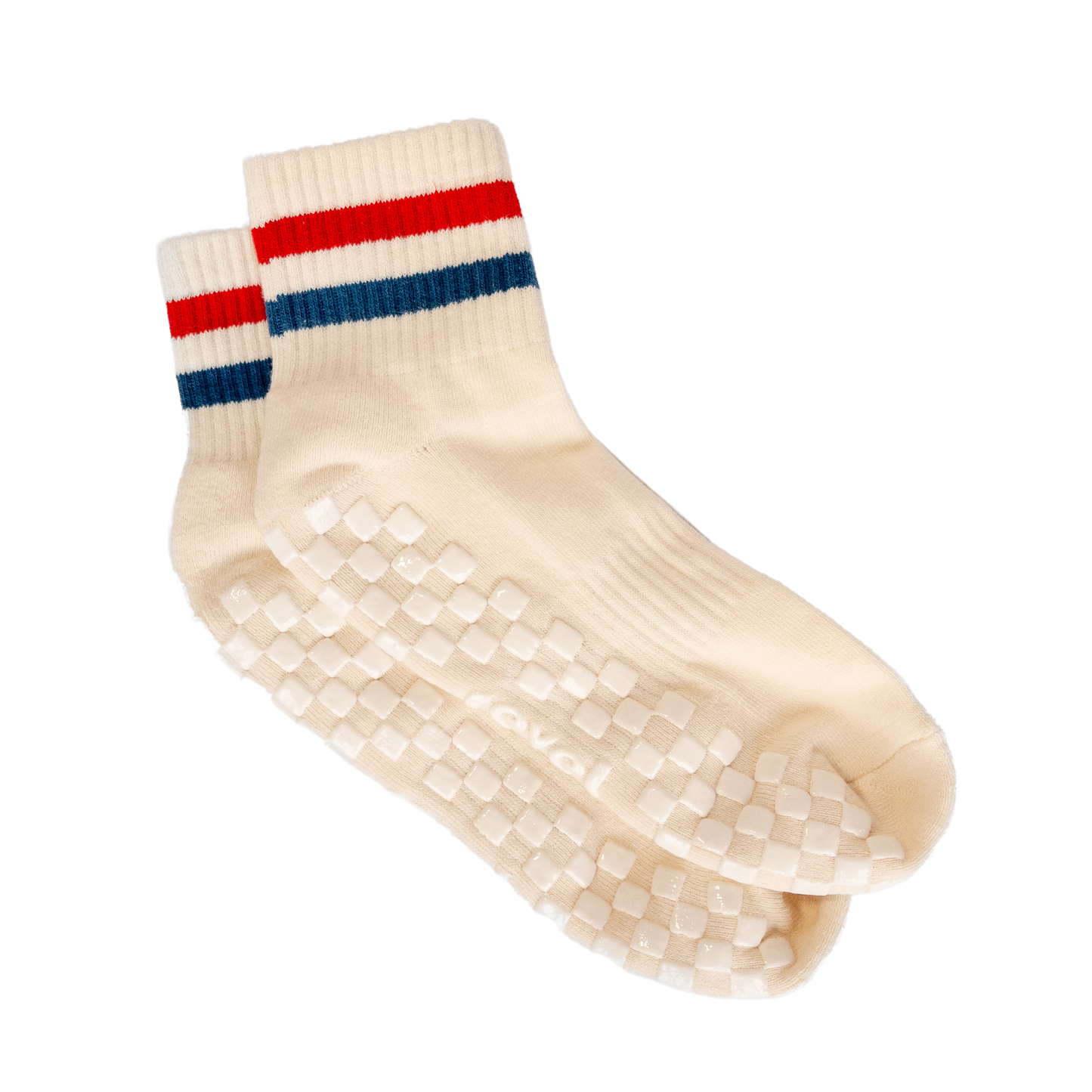 The Miss Americana Grip Sock by Revel is a cream crew pilates sock with red and blue stripes near the top. It has white checkered non-slip grip pads on the soles and “evali” under one sock. Shown against a plain white background.