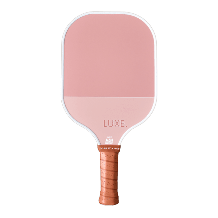 The “Dipped - Ace” by LUXE Pickleball is a pink paddle with aesthetic colors, a rectangular top, rounded edges, and a brown perforated grip. “LUXE.” with “USA” and “kiss my ace” printed near the handle—perfect for pickleball fans.