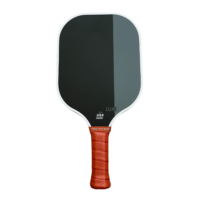 The LUXE Pickleball Dipped - Ace paddle features a black rectangular face with rounded edges, a white border with stylish colors, “USA PICKLEBALL APPROVED” and “LUXE” text, plus a brown perforated grip handle reading "kiss my ace.