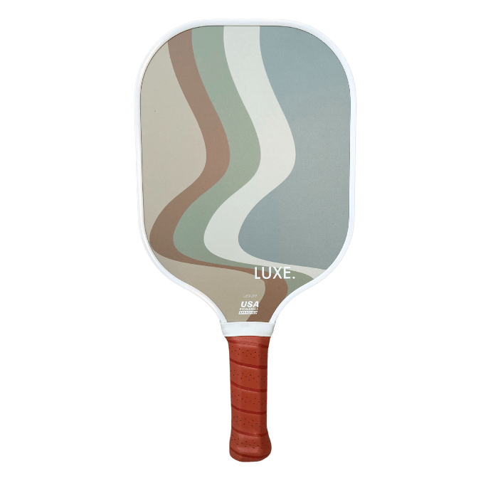 The Luka by LUXE Pickleball is a paddle with a brown grip and abstract wavy lines in green, tan, cream, and gray. It features white edging, "LUXE." at the bottom, and a USA Pickleball Approved logo—perfect for every player.