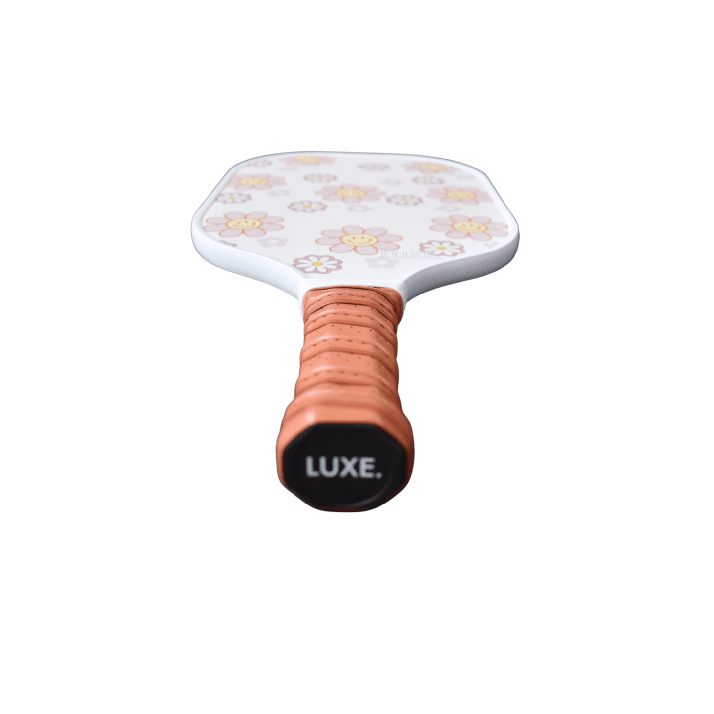 The LUXE Pickleball Smiley Flower paddle, USA Pickleball Approved, features a white face with yellow and pink flowers, a textured light brown grip, and a black end cap labeled LUXE. Shown on white; perfect for beginners.