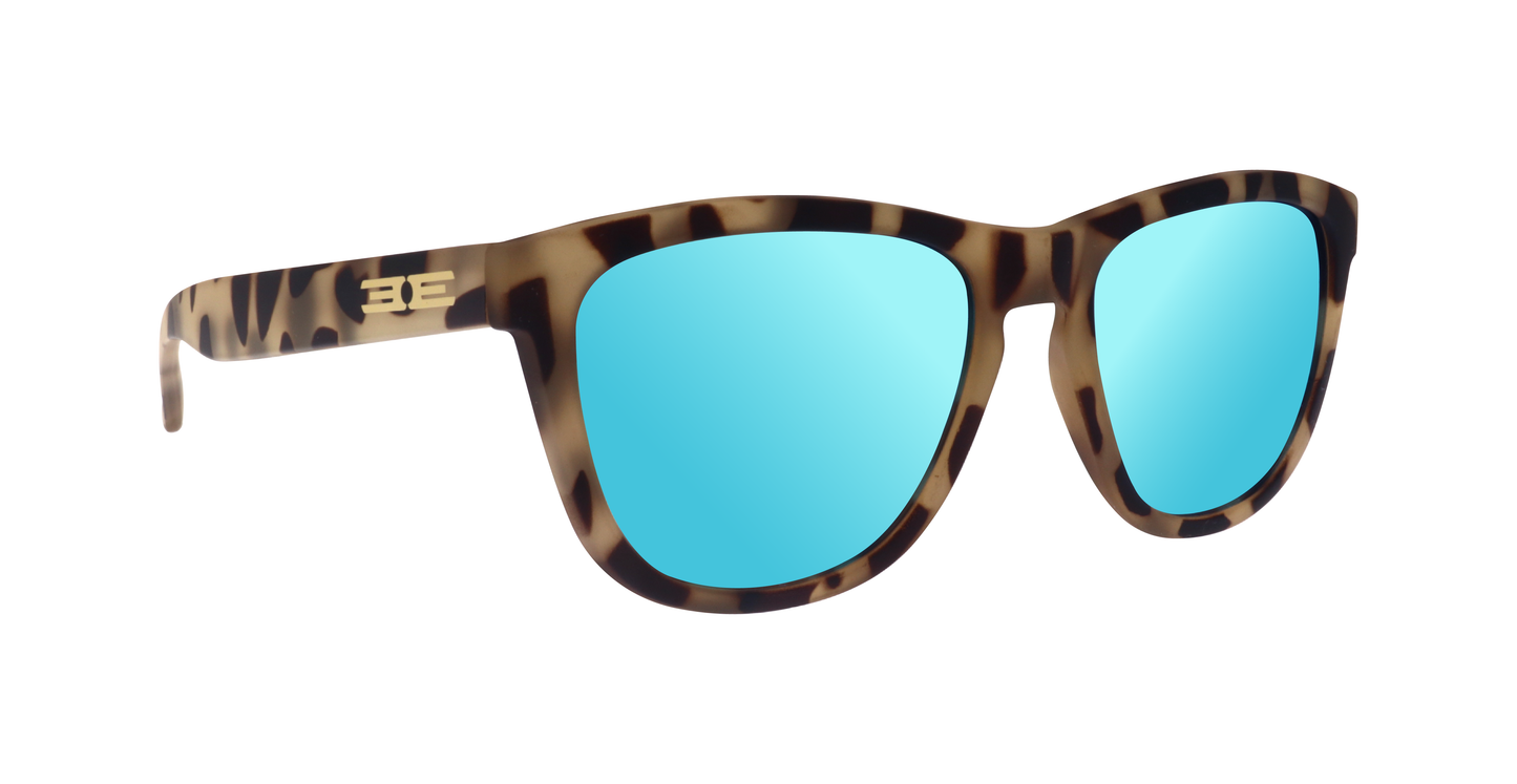 The Epoch Eyewear VIBE sunglasses feature a brown tortoiseshell frame, vibrant blue mirrored lenses, and gold BE logos on the temples, shown angled on a white background.