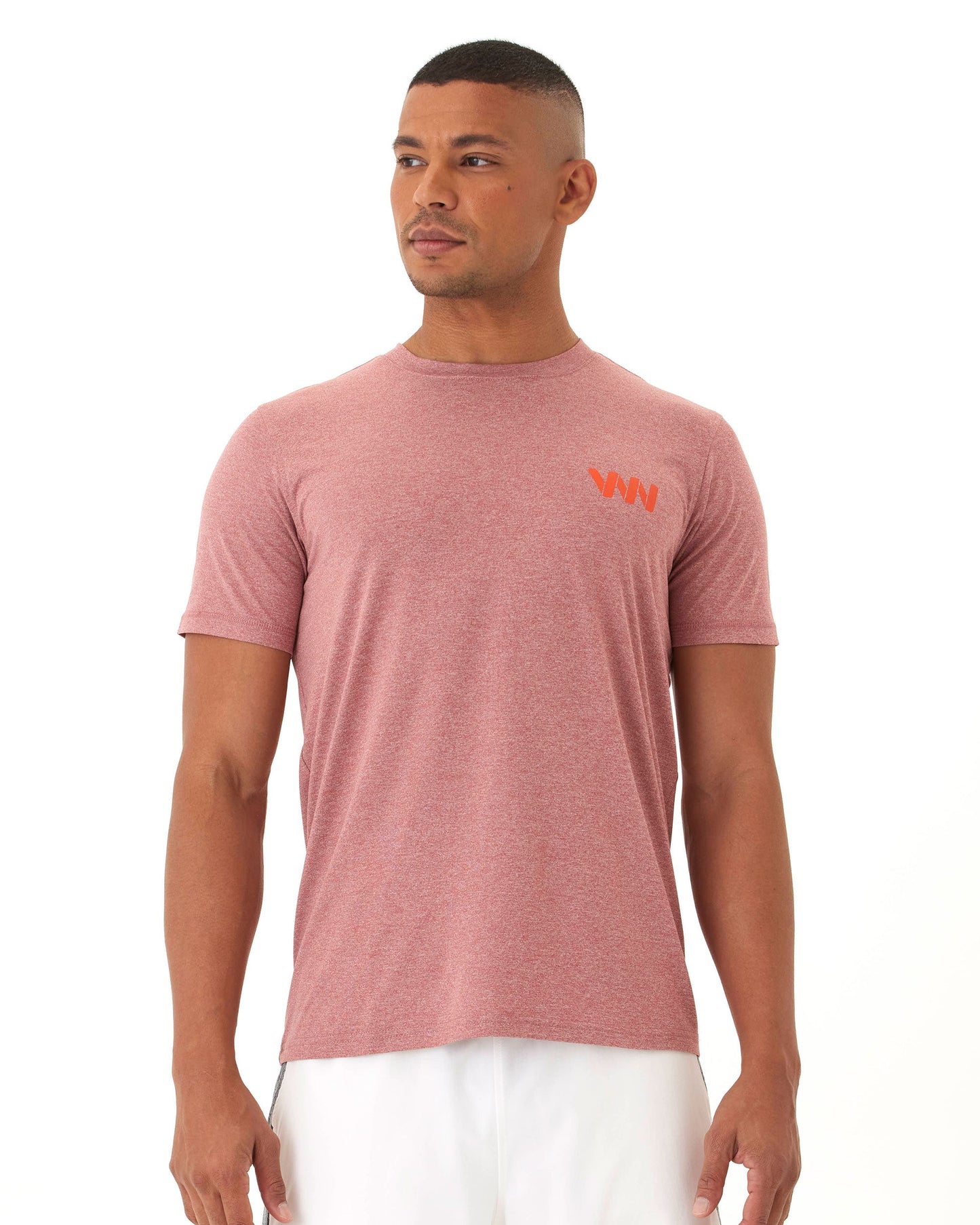A man wears the Wringer Wear Men's Short Sleeve Logo T-shirt in heathered red, featuring an orange logo on the left chest. He stands against a white background, looking slightly left with arms relaxed by his sides.