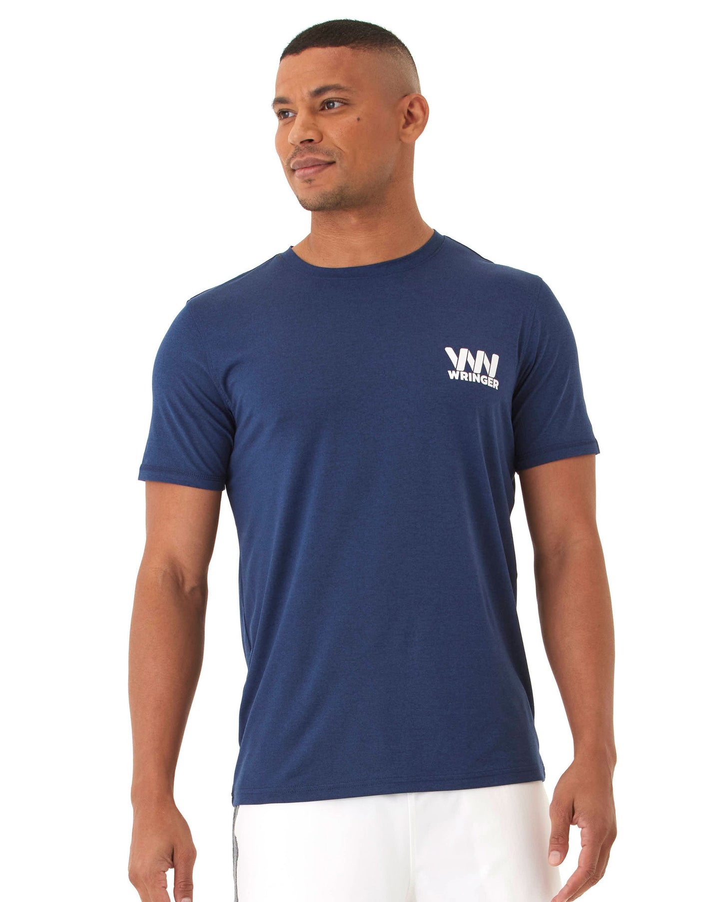 A man with short hair wears the Wringer Wear Men's Short Sleeve Fast Hands Graphic T in navy blue, featuring "WIN WINNER" in white on the left chest, paired with white shorts, standing relaxed against a plain background.