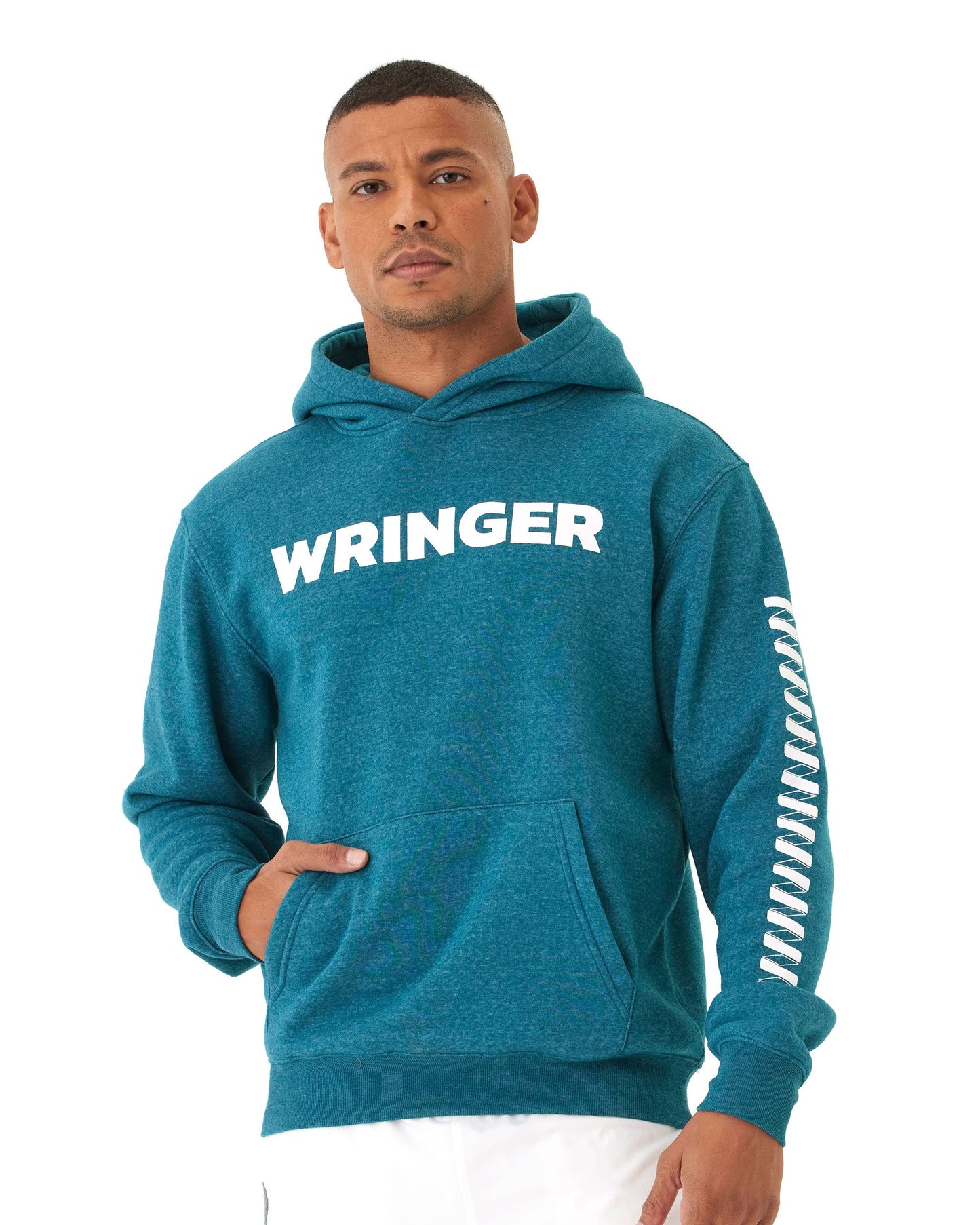 A man with short hair wears the Wringer Wear Men's Core Wringer Graphic Hoodie, featuring bold "WRINGER" text and a zigzag sleeve design. He stands facing forward, hand in pocket, against a plain white background.