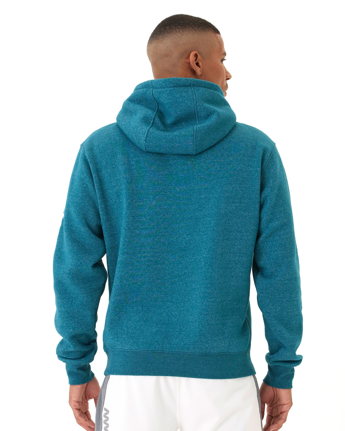 A person stands facing away, wearing a teal Men's Core Wringer Graphic Hoodie by Wringer Wear with the hood down and white athletic shorts. Their arms are relaxed at their sides against a plain white background. This hoodie ensures durable everyday performance.