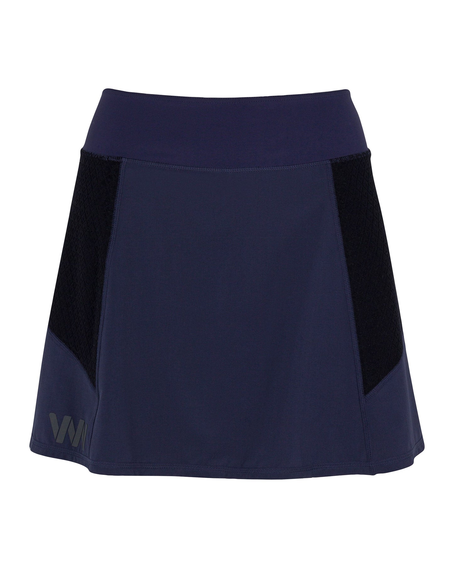 The Indio Skirt by Wringer Wear is a navy athletic skirt with a wide waistband, black mesh side panels, a silver VM logo, and is made from smooth, moisture-wicking fabric in a flattering A-line shape.