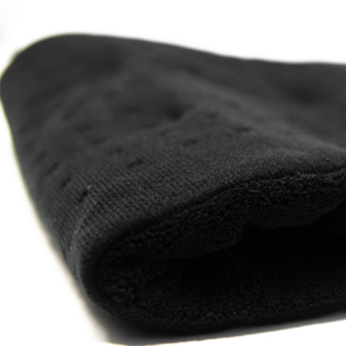 A close-up of the iReliev Weighted Heating Pad on a white background. The textured fabric and quilted stitching are visible, emphasizing its soft material while the back is slightly out of focus.