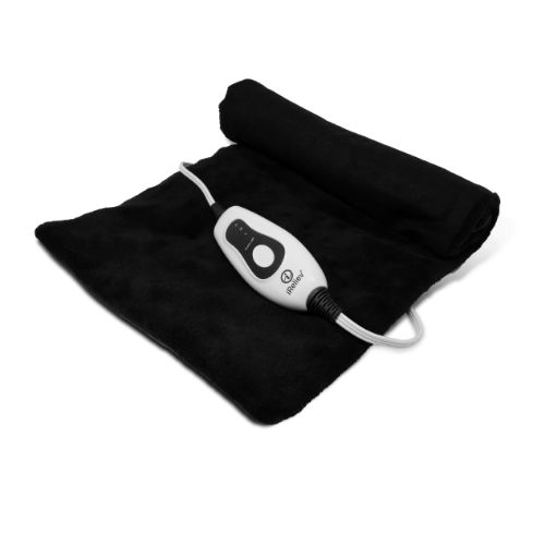 The iReliev Weighted Heating Pad, in black, lies flat on a white surface with one end partially rolled. A white control unit featuring a power button and settings dial sits on top, connected by a coiled cord.