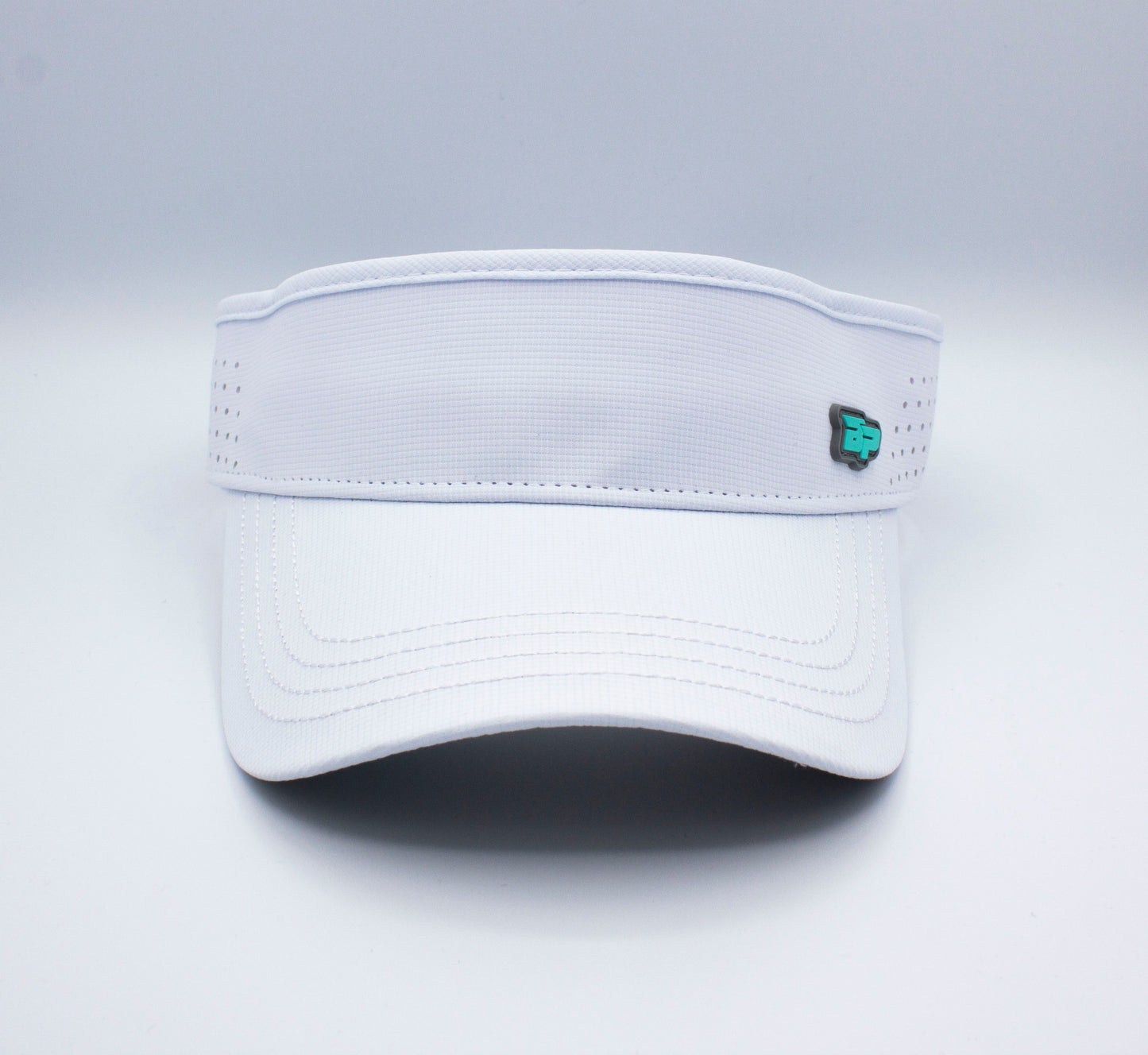 The Bodhi Performance ICON Visor features a white design with a slightly curved brim, band perforations, and a teal-black logo on the right side. Its sleek look stands out against the plain white background.