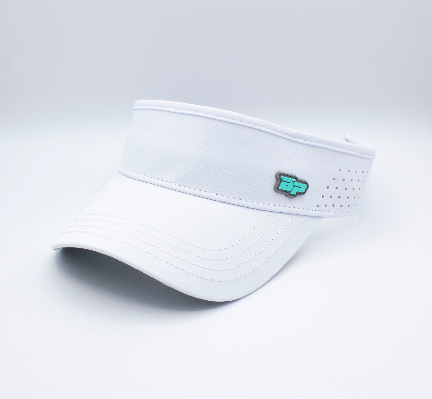 The Bodhi Performance ICON Visor is a white performance visor with curved stitching on the brim, an adjustable back, side blue and white BP logo, ventilation holes along the band—perfect as a pickleball visor. Plain white background.
