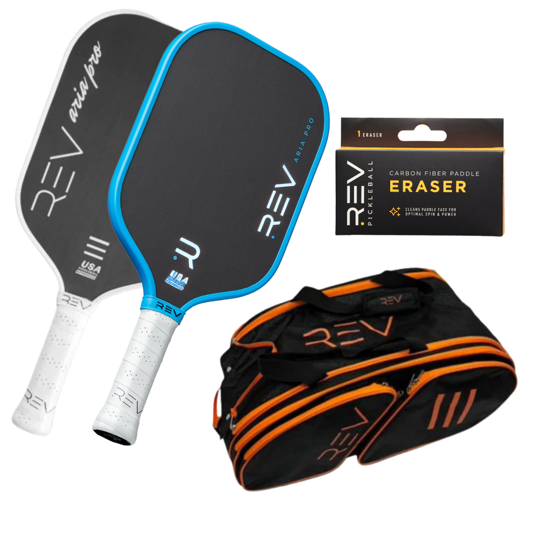 The Professional - Mix & Match - Bundle for 2 by REV Pickleball features two black paddles with white handles (one with a blue edge), a REV paddle eraser, and a duffel bag with orange zippers and logo accents, all shown on a white background.