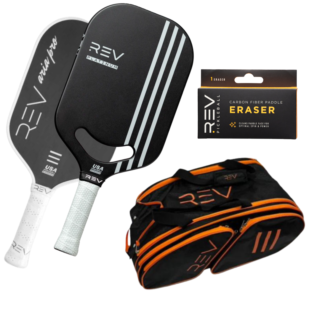 The REV Pickleball "Professional - Mix & Match - Bundle for 2" includes two black paddles with white accents, a branded black and orange sports duffel bag, and a Carbon Fiber Paddle Eraser, all displayed on a white background.