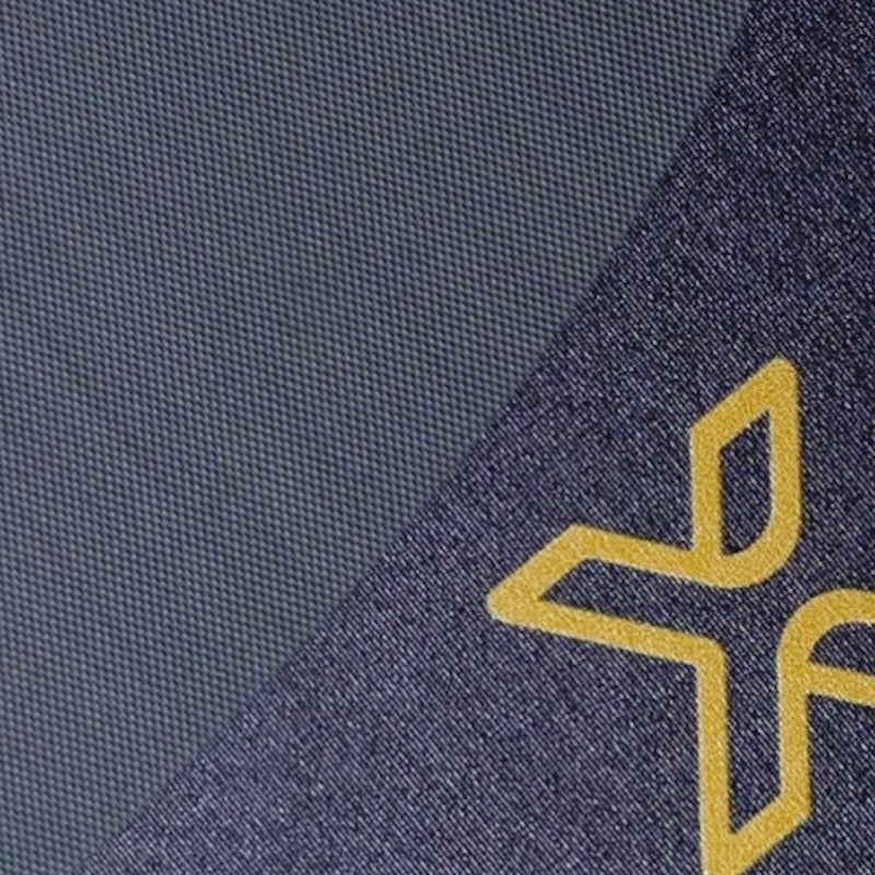 Close-up of the body helix X4 Pickleball Paddle (USAP Approved) shows a textured dark blue surface with a partial yellow X logo, and a diagonal division in premium shades of blue, suggesting T700 raw Toray Carbon Fiber hybrid construction.
