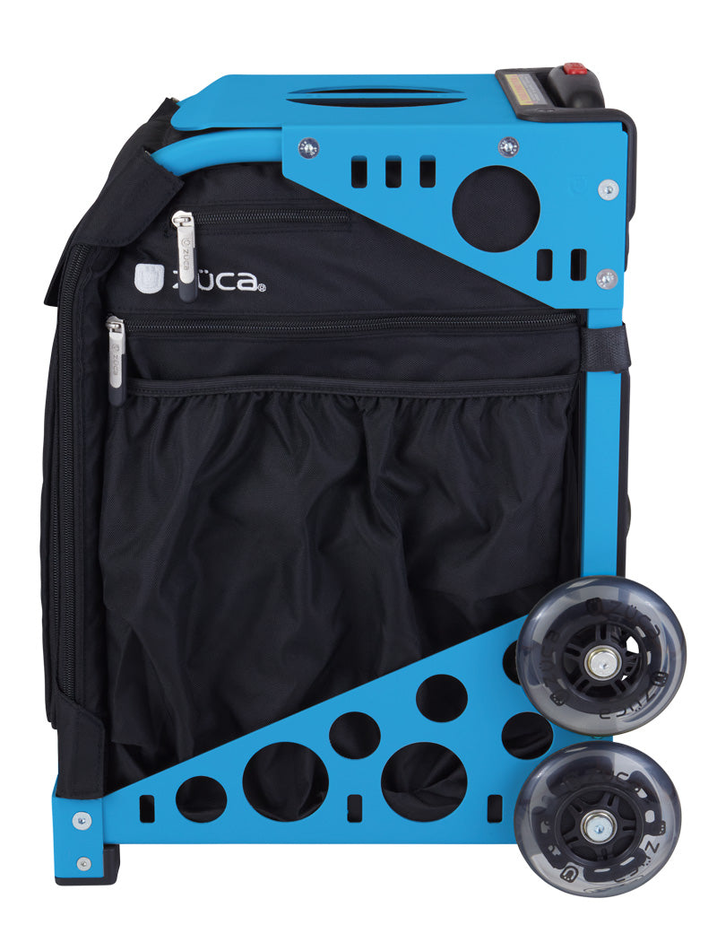 A compact, upright rolling bag by ZUCA, the Pickleball Sport Black/Black features a blue metal frame with circular cutouts, two large clear wheels, and a black fabric front with zippered pockets. The "ZUCA" logo is visible.
