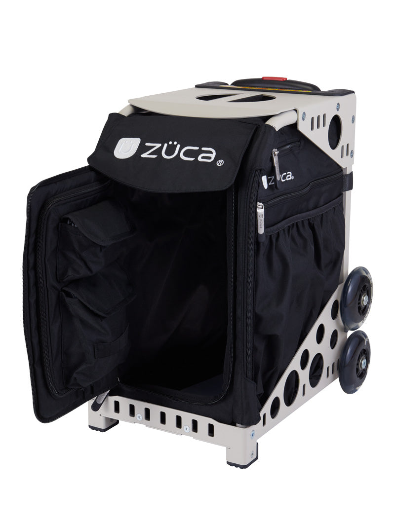 The ZUCA Pickleball Sport Black/Black is a rolling pickleball bag with a hard frame, four wheels, side pouches, top handle, and front zippered flap revealing organized compartments and pockets. The ZUCA logo appears on the front and side.