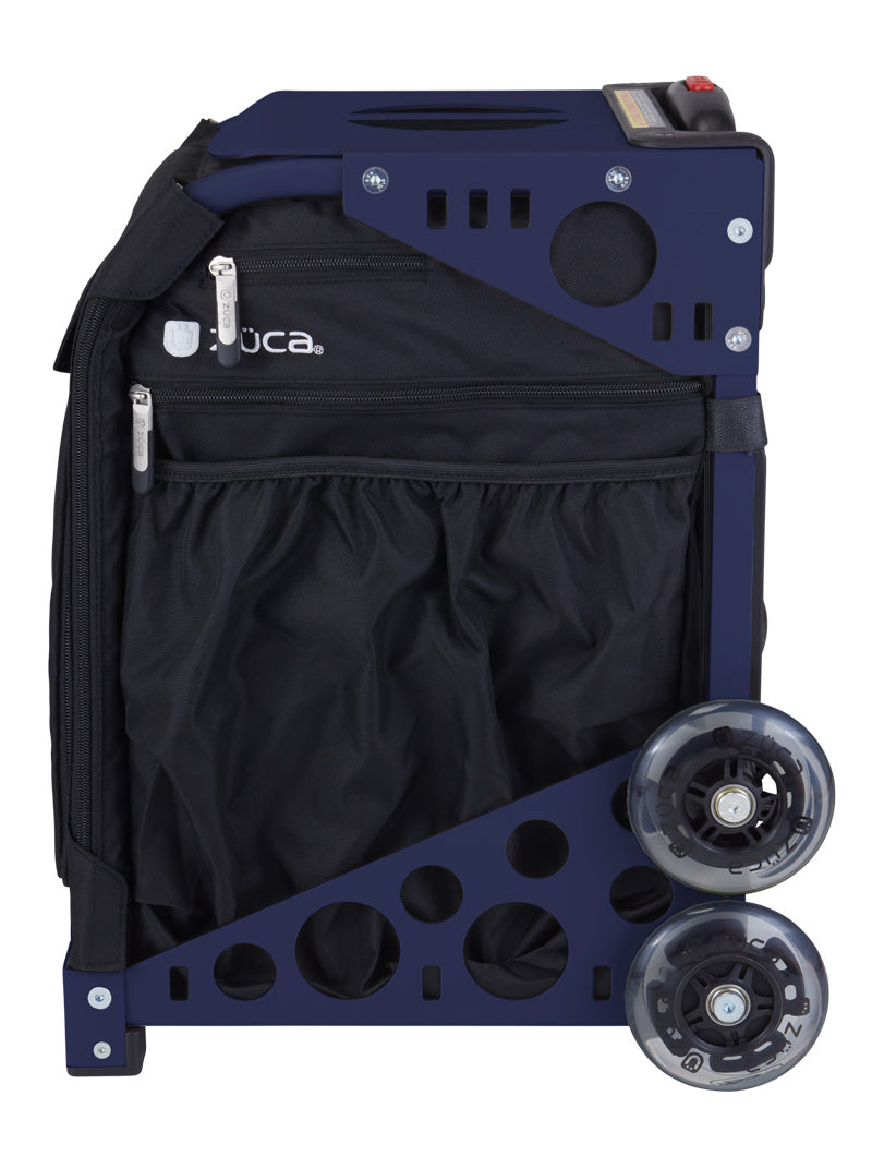 The ZUCA Pickleball Sport Black/Black rolling bag features a black zippered front pocket, mesh pouch, two large transparent wheels, and frame with circular cutouts—perfect for pickleball gear storage. Brand name is near the top zipper.