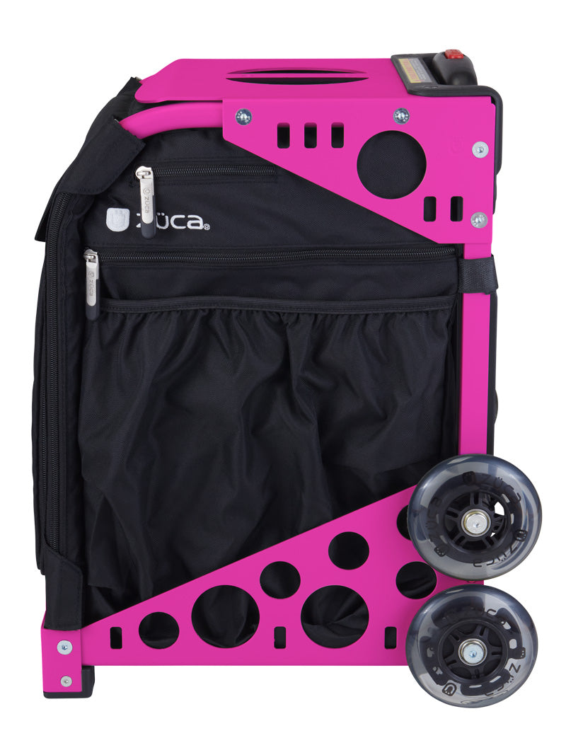 The ZUCA Pickleball Sport Black/Black is a compact, upright rolling bag with large clear wheels, metal frame, outer zippered pockets, mesh storage, and circular cut-out design, shown side view on white.