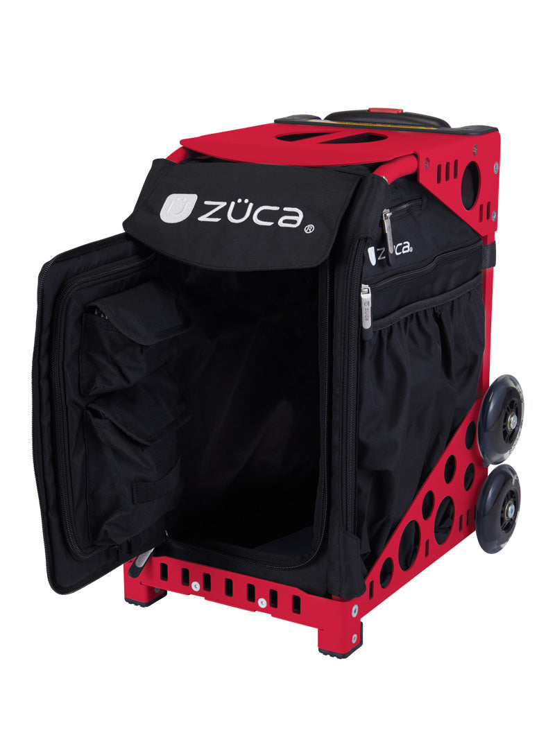 The ZUCA Pickleball Sport Black/Black rolling bag is pictured with its front panel open, showing multiple interior pockets. It features two large wheels per side and a metal frame with circular cutouts for lightweight strength.