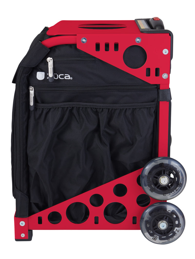 A folded ZUCA Pickleball Sport Black/Black rolling bag with a sturdy red metal frame, two clear wheels, and a black zippered compartment with pockets. Its upright, compact design provides durability, portability, and spacious pickleball storage.