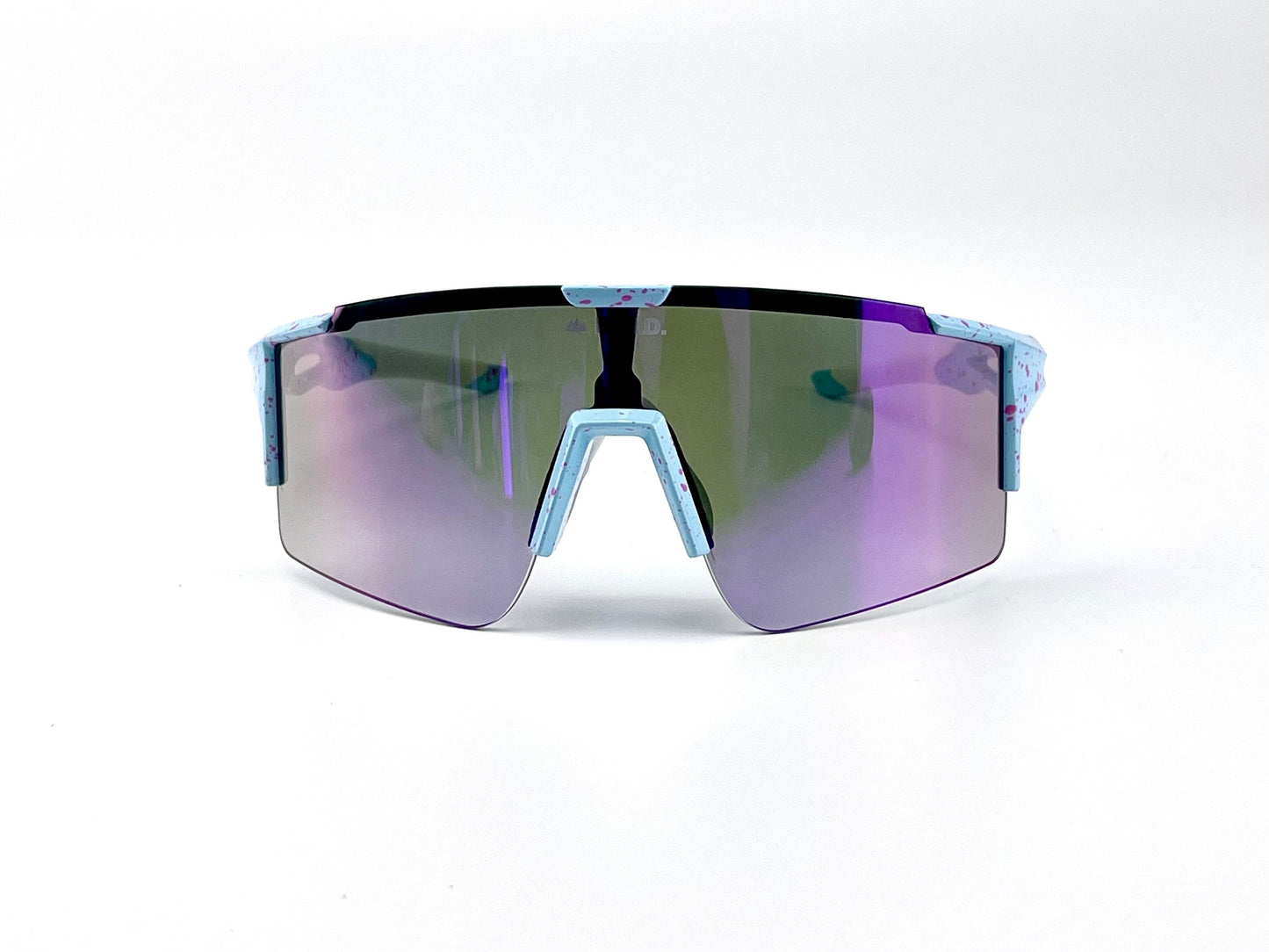 The BOLD Wavelength Performance Sunglasses by boldouterwear feature a single wraparound lens tinted purple and green, a pale blue frame with pink speckles, and an angular, wide top bar—perfect for MTB, ski, or lifestyle use.