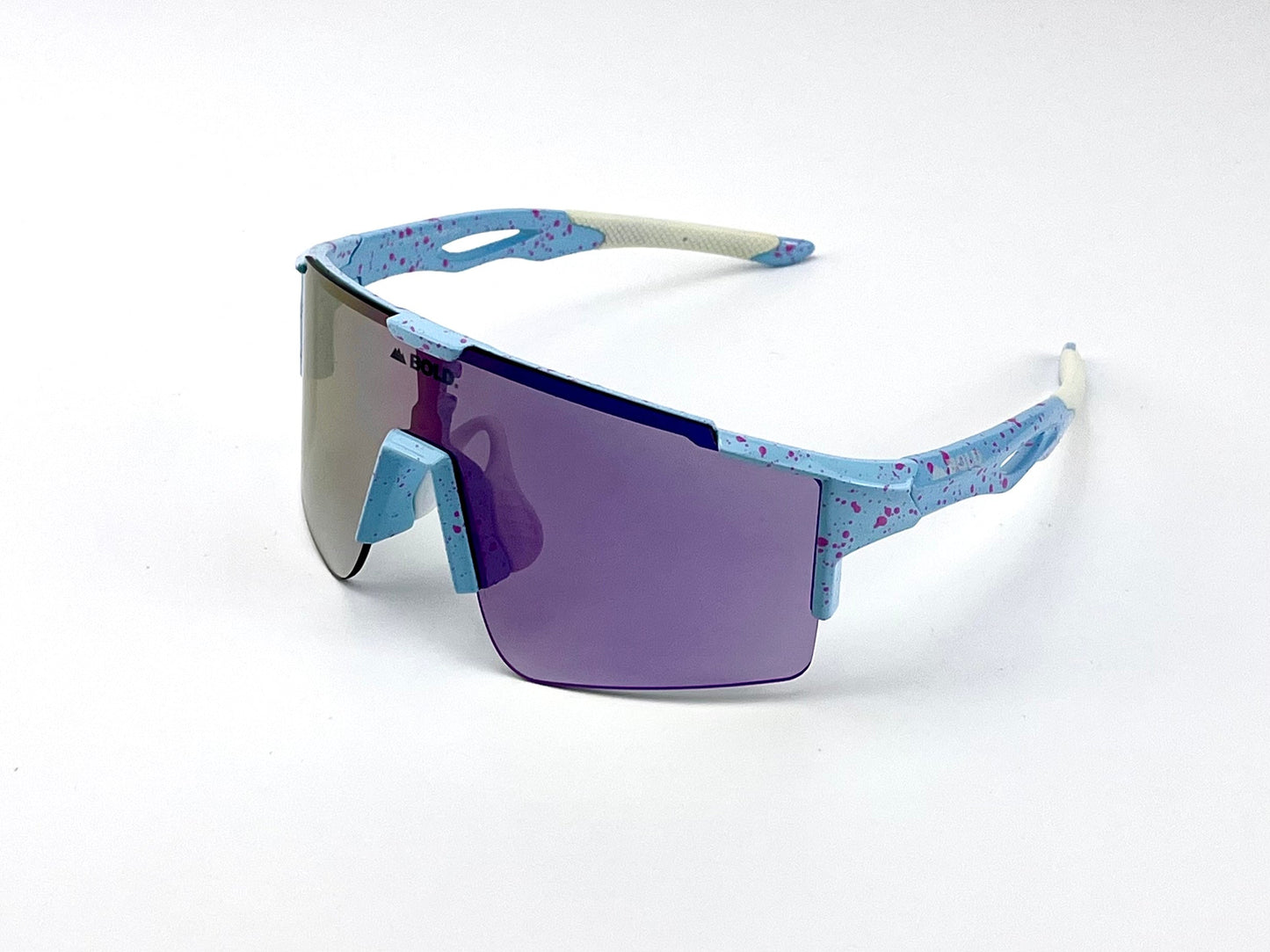 The BOLD Wavelength Performance Sunglasses by boldouterwear feature a blue frame with pink speckles, purple-tinted shield lens, and white ear stems—delivering sporty, futuristic style for MTB, ski, and lifestyle adventures.