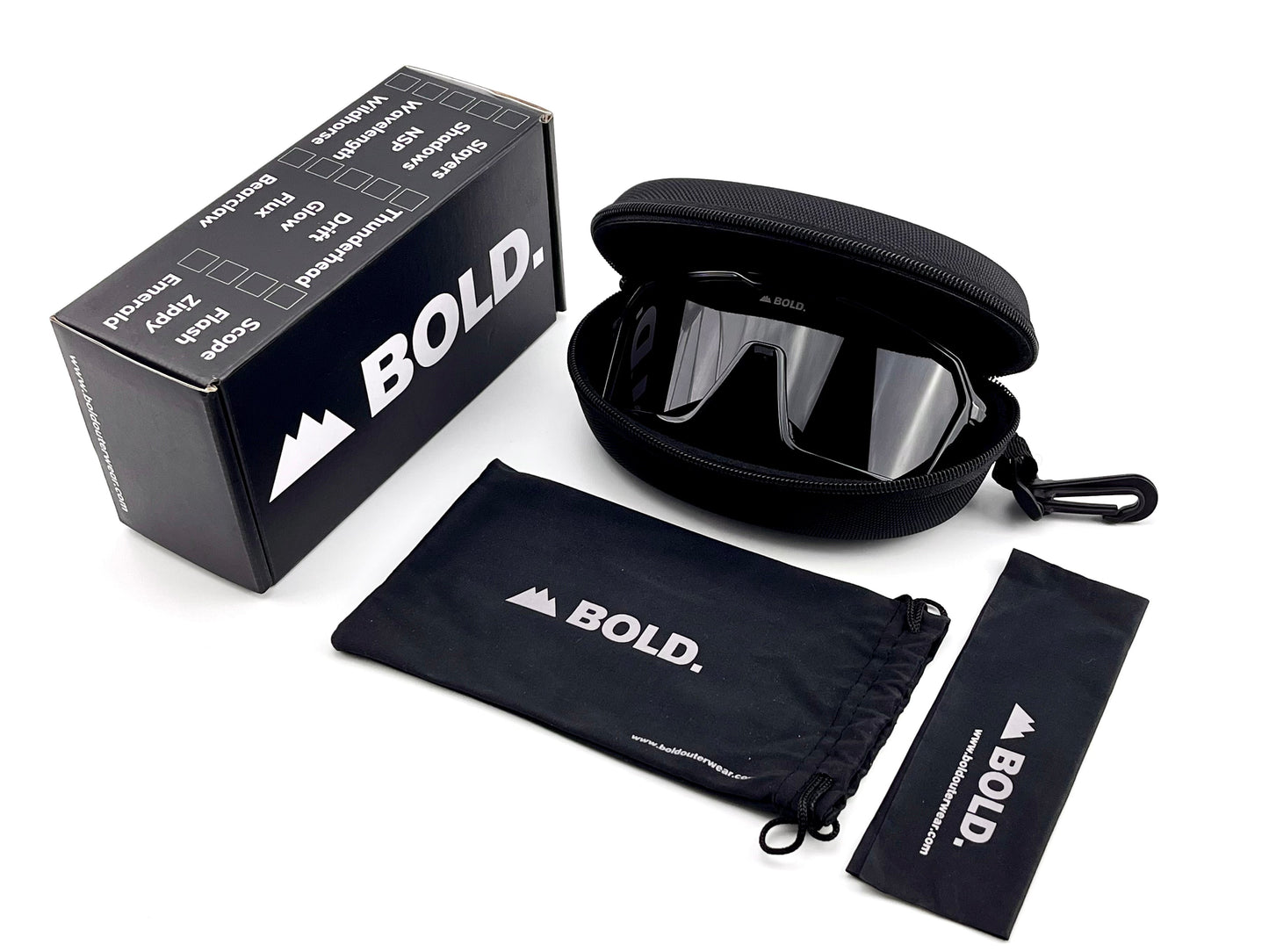 The BOLD Flux Performance Sunglasses by boldouterwear offer UV protection and a mirrored lens, and come with a black carrying case, drawstring pouch, and cleaning cloth—all featuring the BOLD. logo in white on each item and the product box.