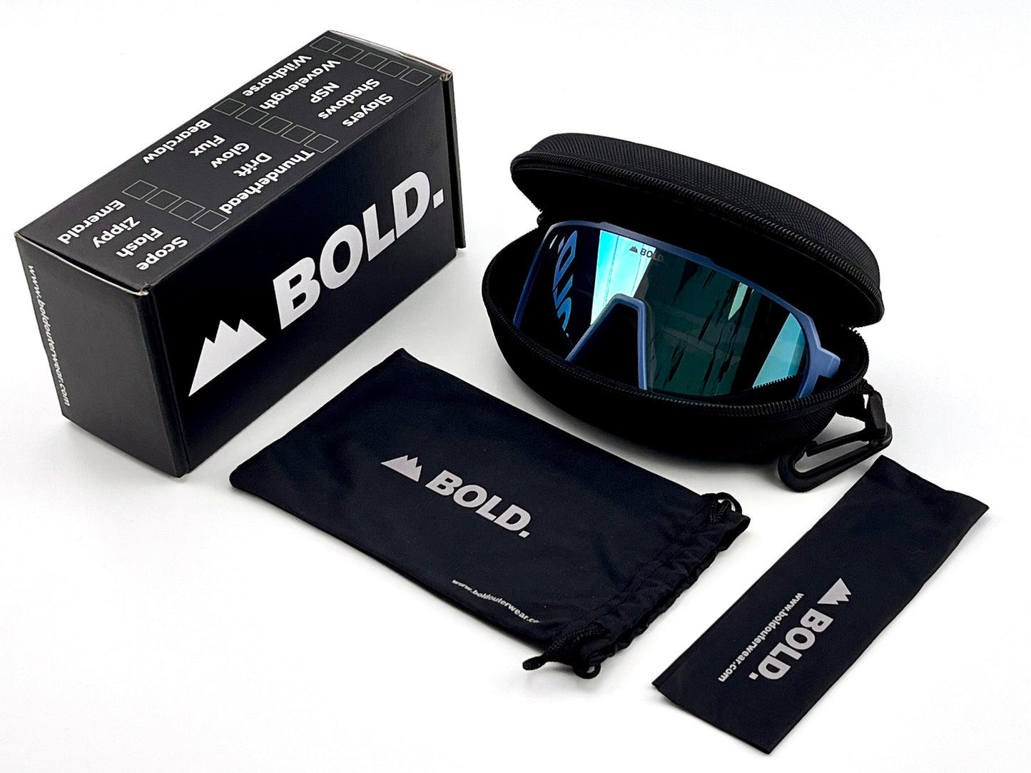 A pair of BOLD Slayers Photochromic Sunglasses by boldouterwear with reflective blue light-adaptive lenses rests in a black zippered case, next to a branded drawstring pouch, wipe cloth, and a black BOLD product box.