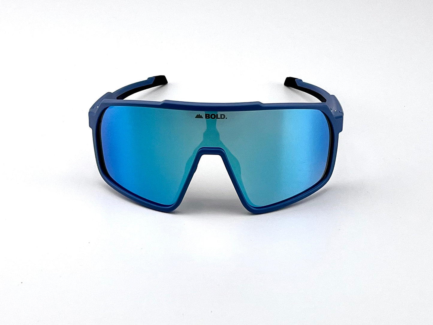 The BOLD Slayers Photochromic Sunglasses by boldouterwear feature a blue oversized frame, large reflective blue lenses, and black-edged arms. Perfect for MTB, ski, and lifestyle wear, these stylish shades adapt to changing light.