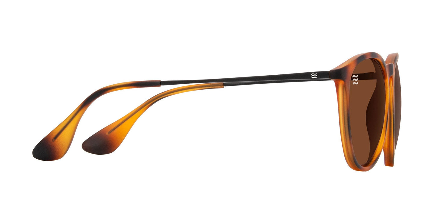 Side view of Neven Eyewear's Bowie sunglasses, featuring a stylish tortoise frame with lightweight TR90, thin black metal arms, brown polarized UV400 lenses, and outward-curving earpieces with rounded teardrop-shaped tips.