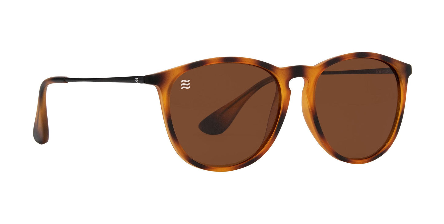 The Bowie by Neven Eyewear features round tortoise frames with brown polarized UV400 lenses, a keyhole bridge, and dark slim temples. Made from lightweight TR90, these stylish shades offer comfort in mottled brown and amber hues.