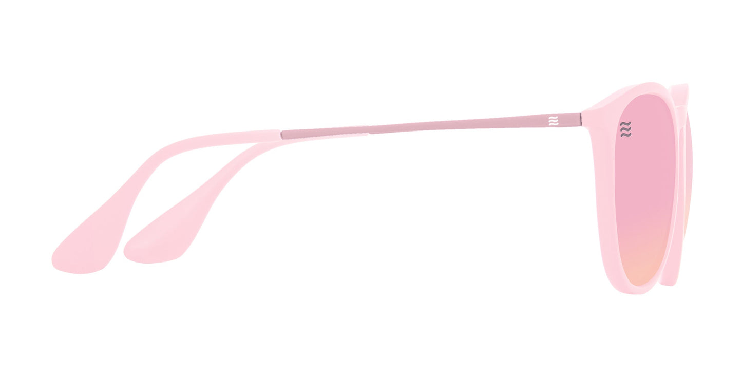 Side view of Neven Eyewear's Dreamy sunglasses featuring pink polarized, UV400 impact-resistant round lenses, thin arms with a metallic accent at the hinge, and a sleek, lightweight frame for a modern look.