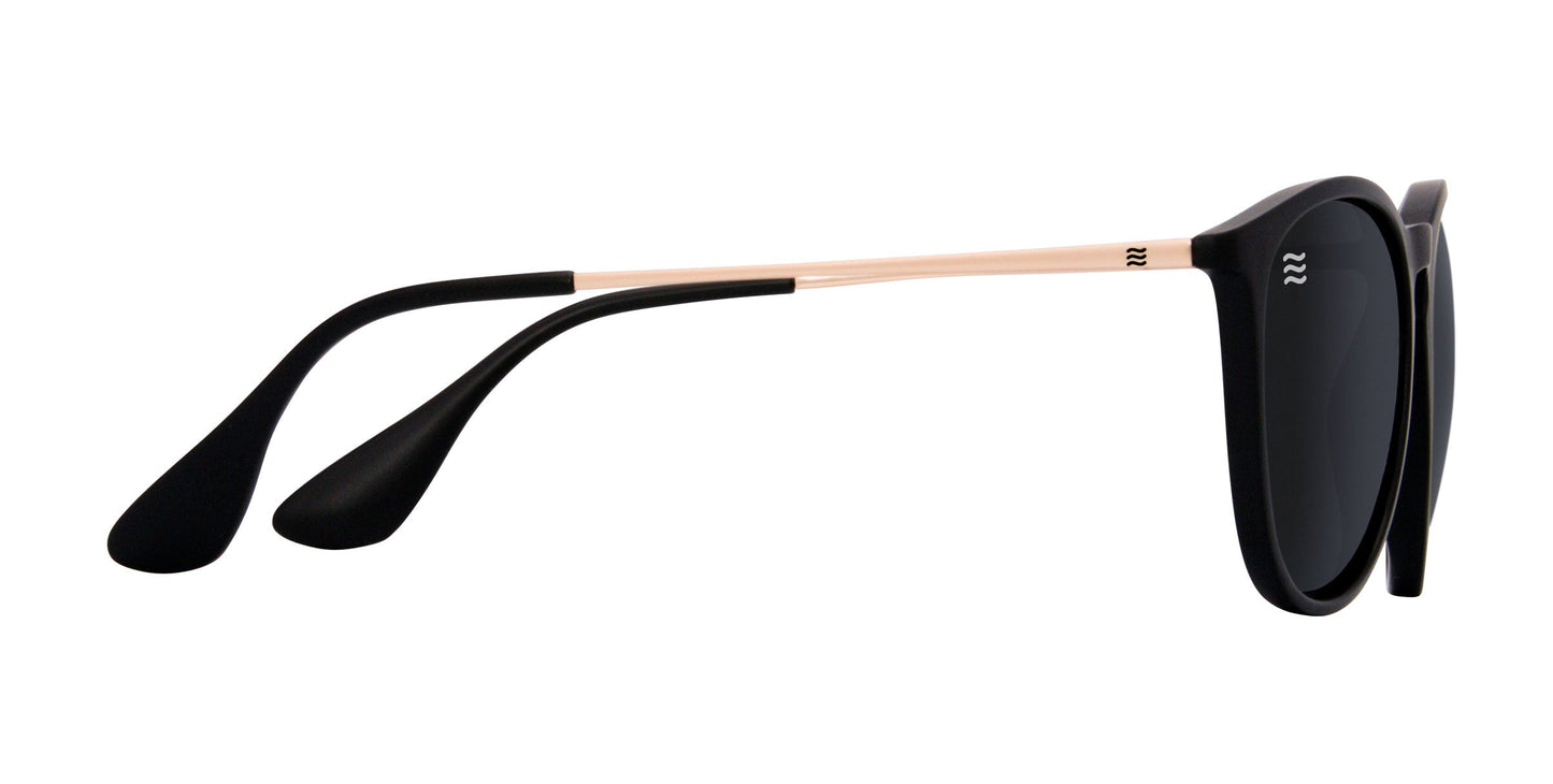 The Neven Eyewear Goldie Lux features a sleek round frame with thin gold metal arms and black tips. These polarized sunglasses offer UV400 protection, blending modern style and comfort for an eye-catching look.