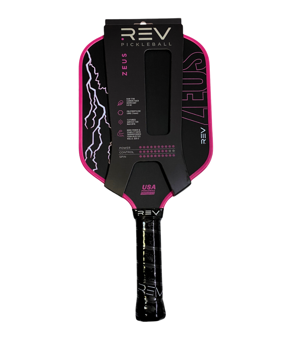 The ZEUS Pickleball Paddle by REV Pickleball is a thermoformed paddle with a black face, pink edges, and purple lightning graphics. It has a black grip marked "REV" and packaging features T700 Raw Carbon Fiber and USA manufacturing. Displayed vertically.