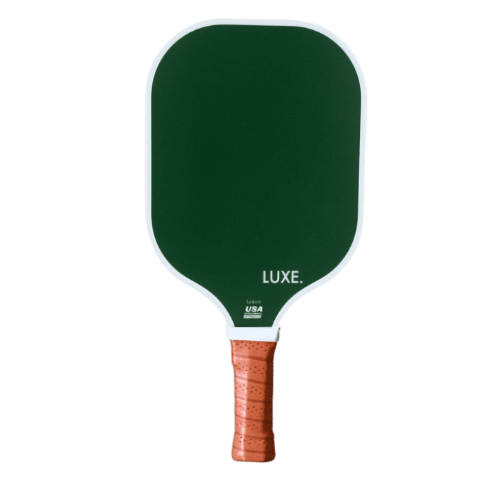 The LUXE Pickleball Aesthetic Solids - Leisure paddle has a dark green fiberglass rectangular face with rounded edges, a brown perforated grip, “LUXE.” branding, USA label at the base, and a honeycomb core. Plain white background.