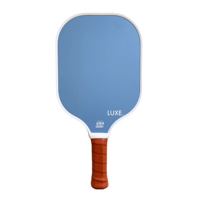 A blue fiberglass LUXE Pickleball Aesthetic Solids - Leisure paddle with a white border, honeycomb core, brown textured grip, and USA Pickleball Approved in white text, shown on a plain white background.