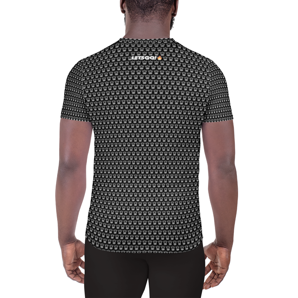 A man, seen from behind, wears Crown Pickleball's Men's Corona Pattern Shirt (Black), a fitted moisture-wicking tee with small light gray skulls. "Jitsogi" appears in white with an orange detail near the collar against a plain white background.