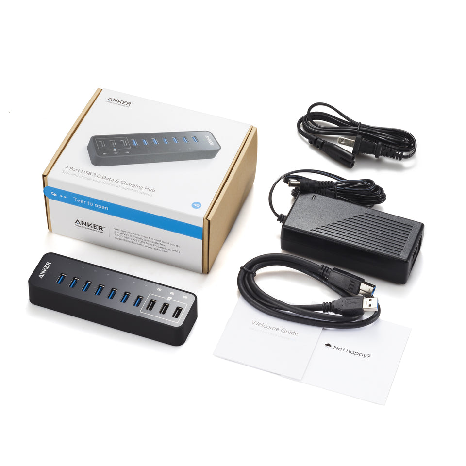 The image displays an Anker 60W 10-Port USB 3.0 Data Hub set, including a power adapter, USB cable, welcome guide, “Not happy?” card, and box—all items neatly arranged on a white background.