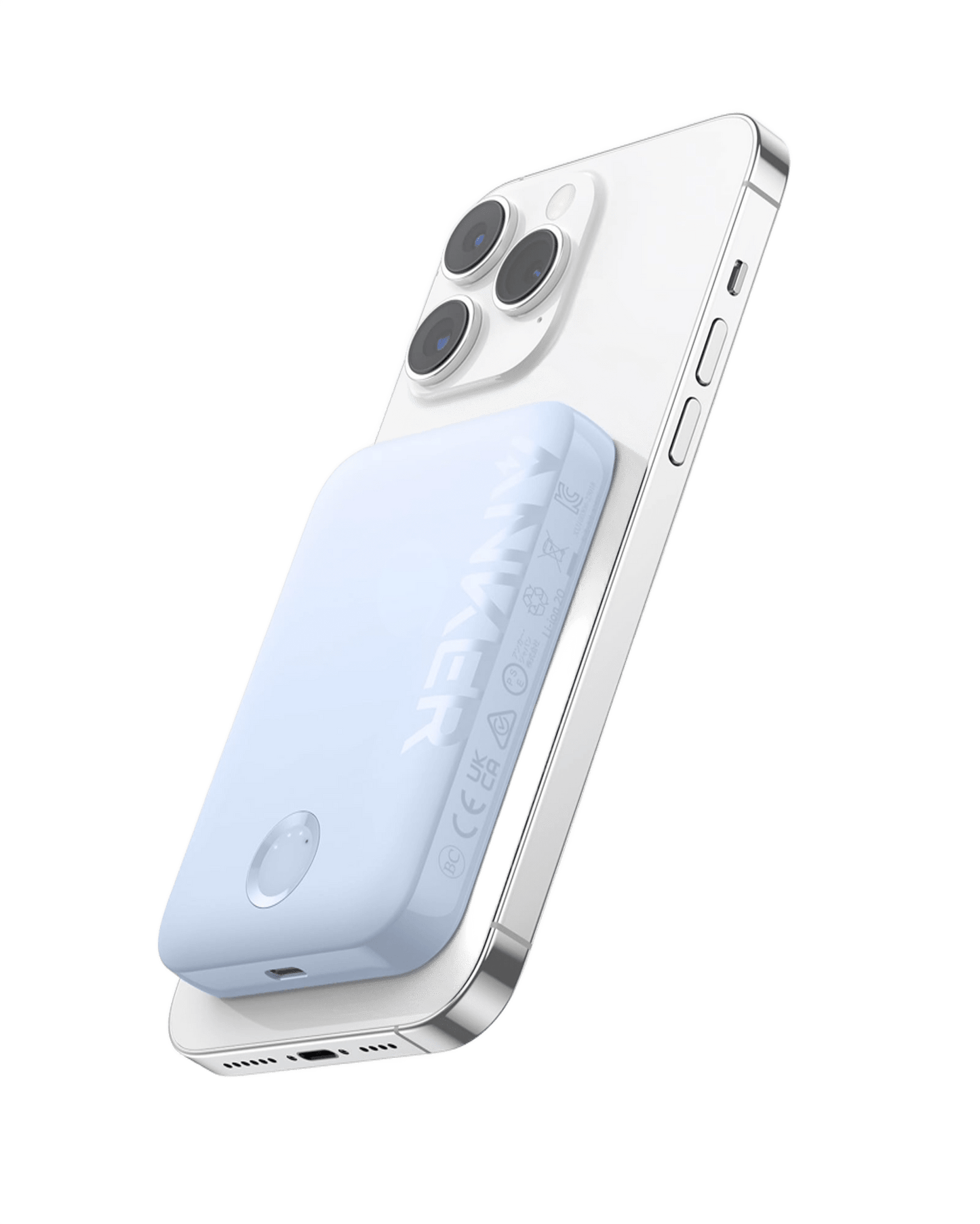A silver smartphone with three rear cameras has a light blue, rectangular Anker 321 MagGo Battery (PowerCore Magnetic 5K) magnetically attached to its back. Both are shown from a rear-side angle on a white background.
