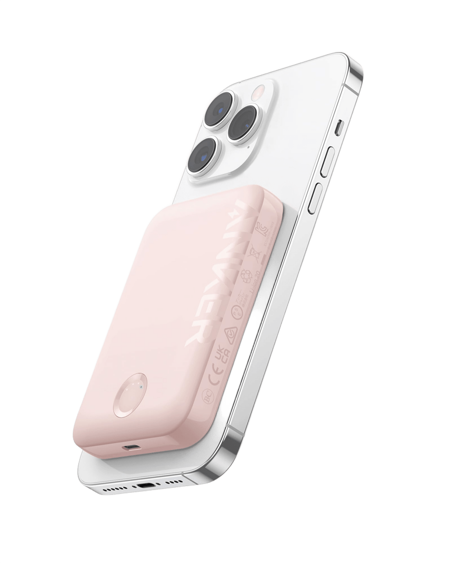 A white smartphone with three rear cameras has a pink Anker 321 MagGo Battery (PowerCore Magnetic 5K) magnetically attached to its back. The ANKER logo and certification icons are visible, shown against a plain white background.