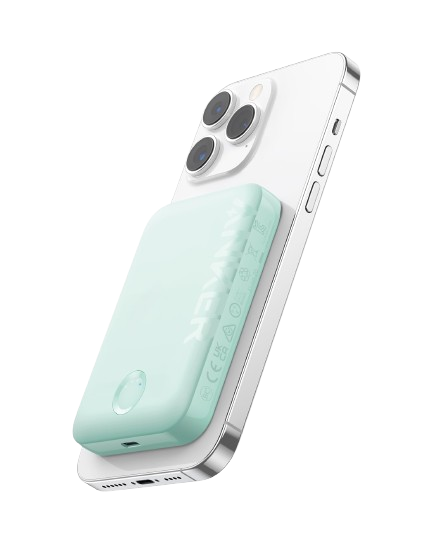 A mint green Anker 321 MagGo Battery (PowerCore Magnetic 5K) by Anker is magnetically attached to the back of a white smartphone with three rear cameras and silver edges, set against a plain white background.