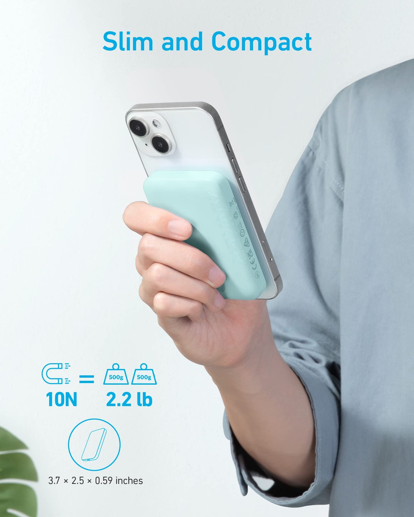 A person holds a smartphone with the Anker 321 MagGo Battery (PowerCore Magnetic 5K) by Anker, a slim, compact power bank attached magnetically (10N), weighing 2.2 lb and measuring 3.7 x 2.5 x 0.59 inches.