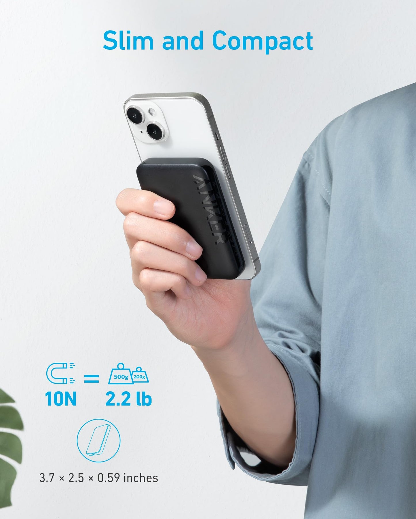 A person in a light blue shirt holds a white smartphone with the Anker 321 MagGo Battery (PowerCore Magnetic 5K) by Anker, a slim, compact black charger measuring 3.7 x 2.5 x 0.59 inches that supports up to 10N (2.2 lb) magnetic force. Text: "Slim and Compact.
